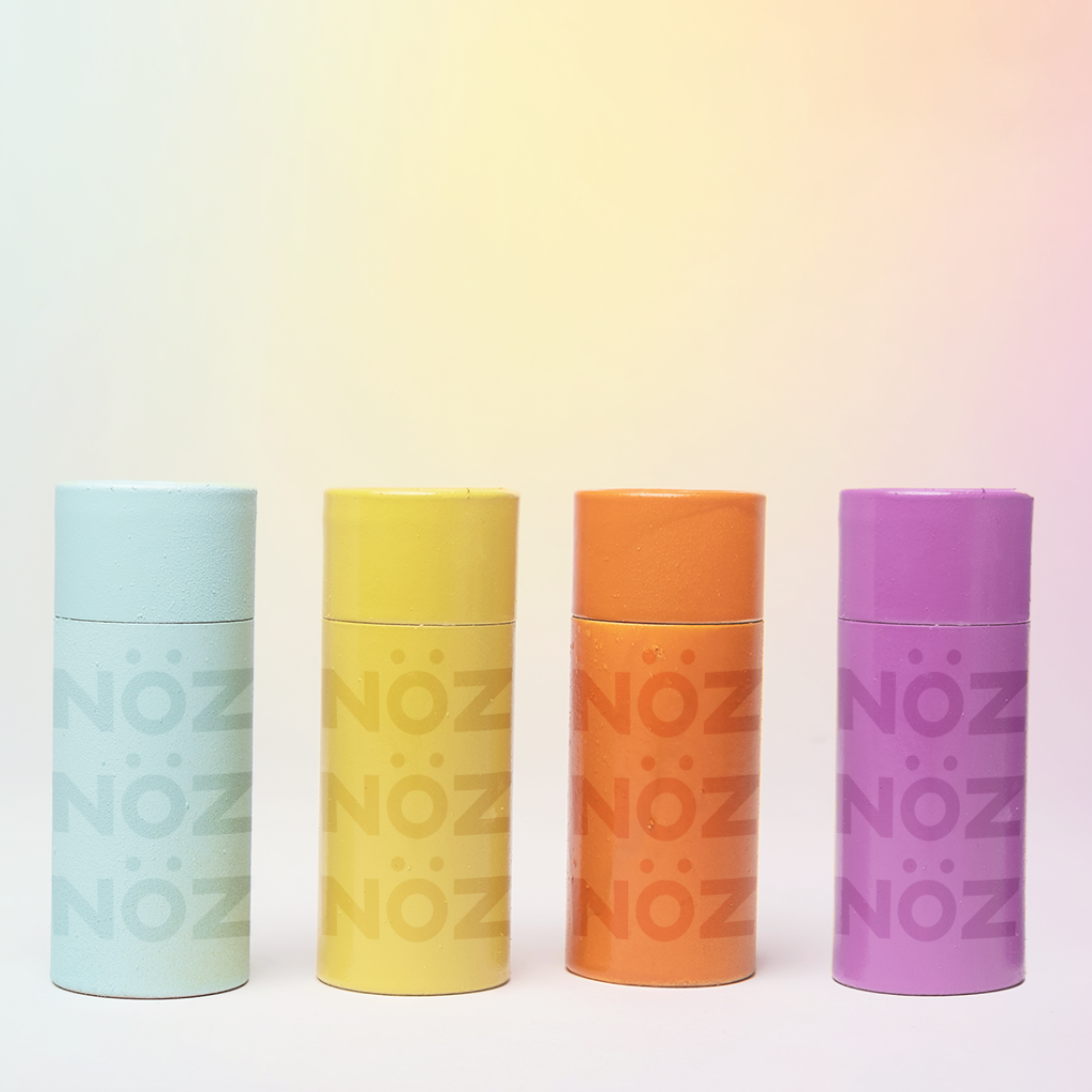 The colorful Nöz SPF in neon blue, neon yellow, neon orange, and neon purple.