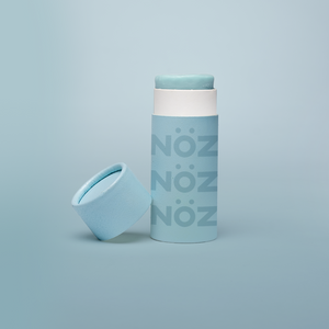 Reef safe, cruelty-free neon blue Nöz sunscreen in a blue background