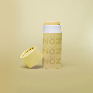 Reef safe, cruelty-free neon yellow Nöz sunscreen in a light yellow background